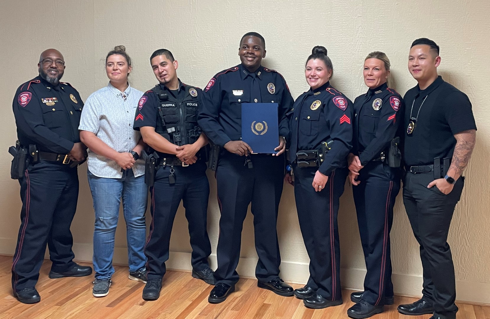 Picture of Officer Eric Crosby accepting award, Picture left to right, Assistant Police Chief Powell, Officer Vieceli, Officer Guerra, Officer Crosby, Officer Burns, Officer Bruno, Officer Ha